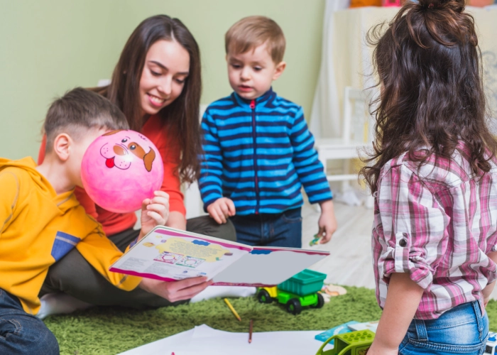 Teacher guiding children at a preschool near me